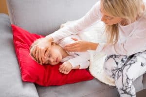 Mother looking after her sick child at home
