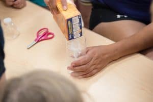 Daycare teacher helping children