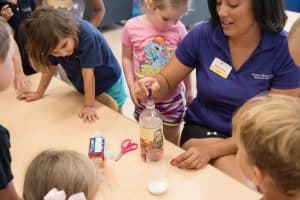 Childcare teacher helping children