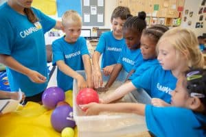 Children doing a science experiment with balloons and water