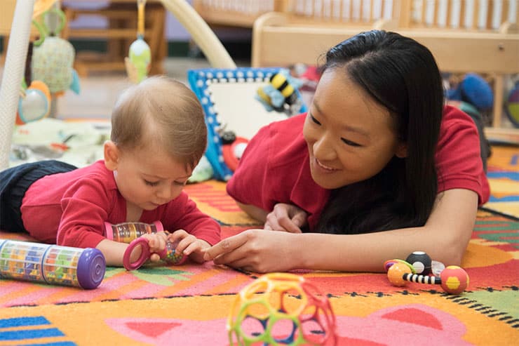 A baby touching a toy