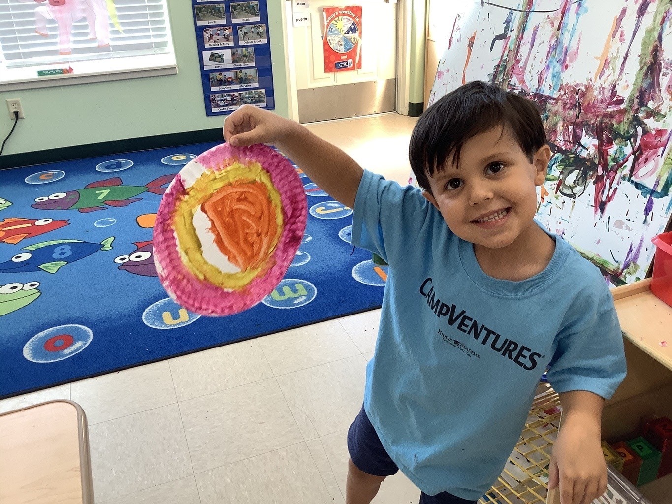 kiddie academy student showing artwork